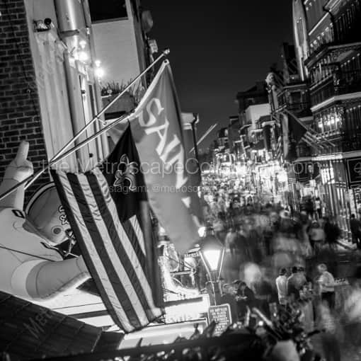 Saints Flag Hang above Bourbon Street -- New Orleans Black and White Framed Photos