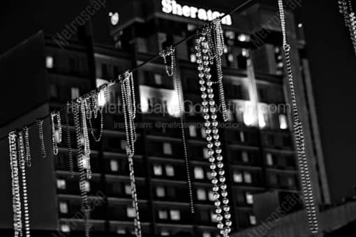 New Orleans Black and White Photography of Beads Hang above Bourbon Street in the French Quarter Beads Hang above Bourbon Street in the French Quarter -- New Orleans Black and White Photography