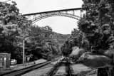 Horizontal The New River Gorge Bridge over Railroad Tracks black and white Photos