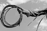 Horizontal A Spool of Rope in Cowboy's Hand black and white Pictures