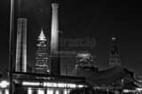 Horizontal The Key Bank Building is Framed by Smoke Stacks from the Rock Bottom Brewery black and white Photos