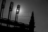 Horizontal The Sun Shining Through the Lights at Jacobs Field. landscape black and white Photography