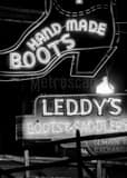 Vertical Leddys Handmade Boots and Saddles black and white Photos