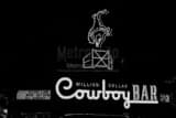 Horizontal The Million Dollar Cowboy Bar Sign black and white Photos
