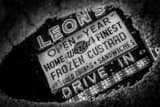 Horizontal Leons Frozen Custard Sign in Puddle black and white Photos