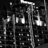 Square Beads Hang above Bourbon Street in the French Quarter black and white Photos