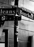 Vertical Bourbon Street and Orleans Street Signs black and white Photos