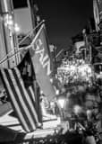 Vertical Saints Flag Hang above Bourbon Street Framed Photos