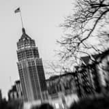 Square The American Flag Flies from Tower Life Building Framed Photos