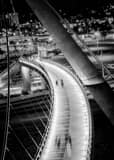 Vertical Walkers on the Harbor Drive Pedestrian Bridge night time black and white Photography