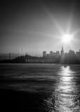 Vertical A Back-lit Bay Bridge and San Francisco Skyline at Dawn black and white Photos
