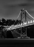 Vertical The Bay Bridge Feeds into Yerba Buena Island black and white Photos