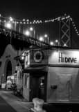 Vertical The Hi Dive Bar along the Embarcadero under the Bay Bridge black and white Photos