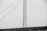 Horizontal The Lone Spire of the Eastern Bay Bridge Under Mist and Fog black and white Photos