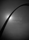 Vertical The Gateway Arch Silhouetted by the Sun black and white Photos